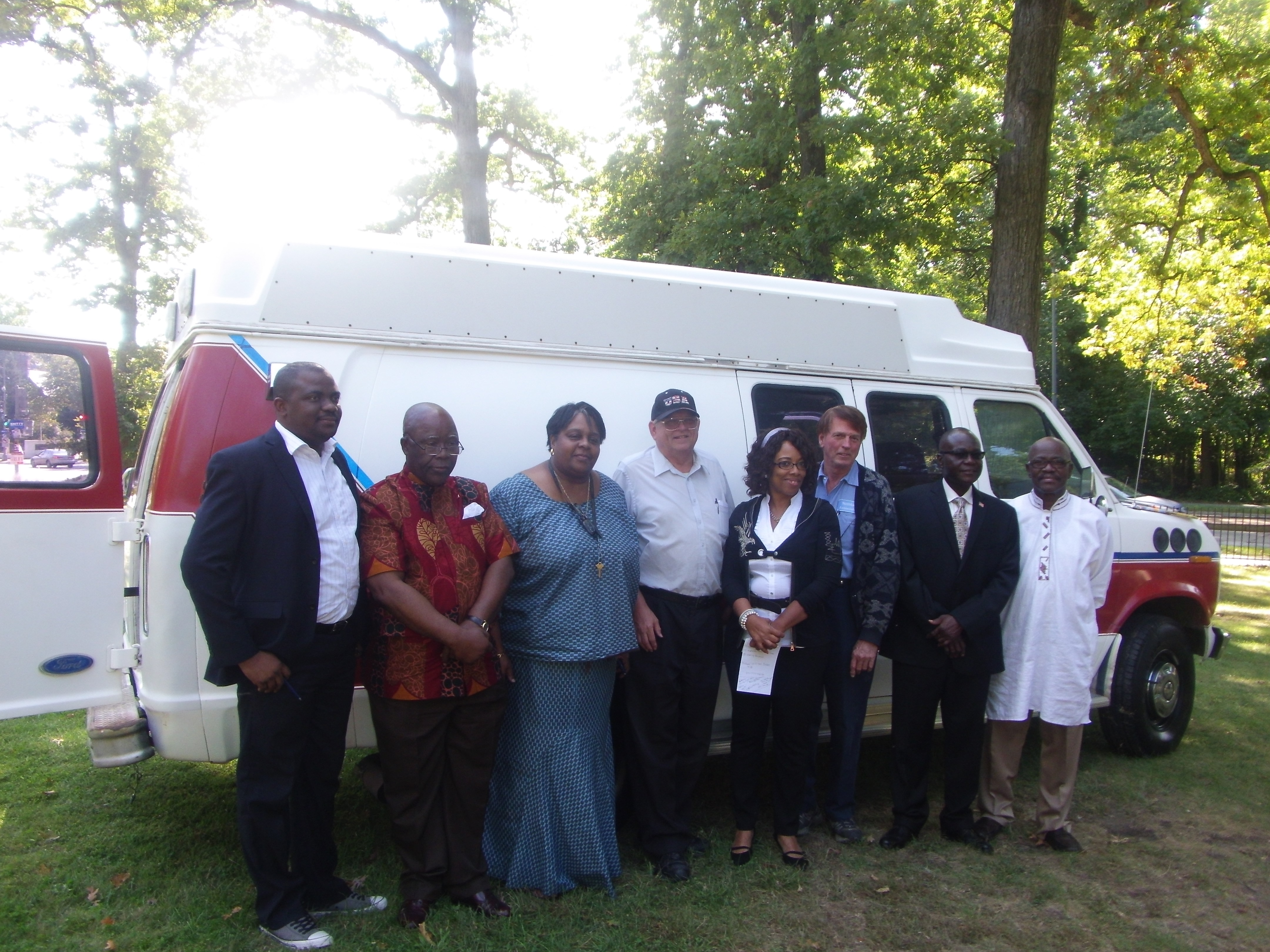 Embassy officials posed with the Nethken brothers during the ambulance donation