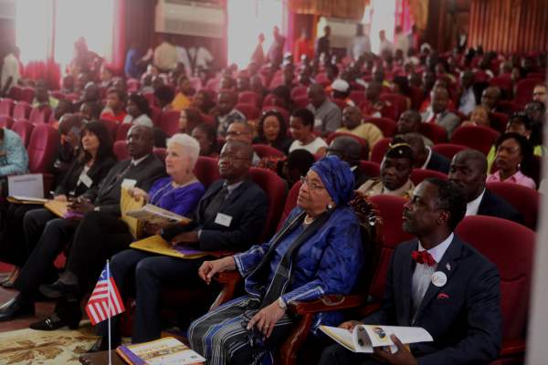 . President Sirleaf and guests watch a presentation during the opening of the MSME Conference 2015